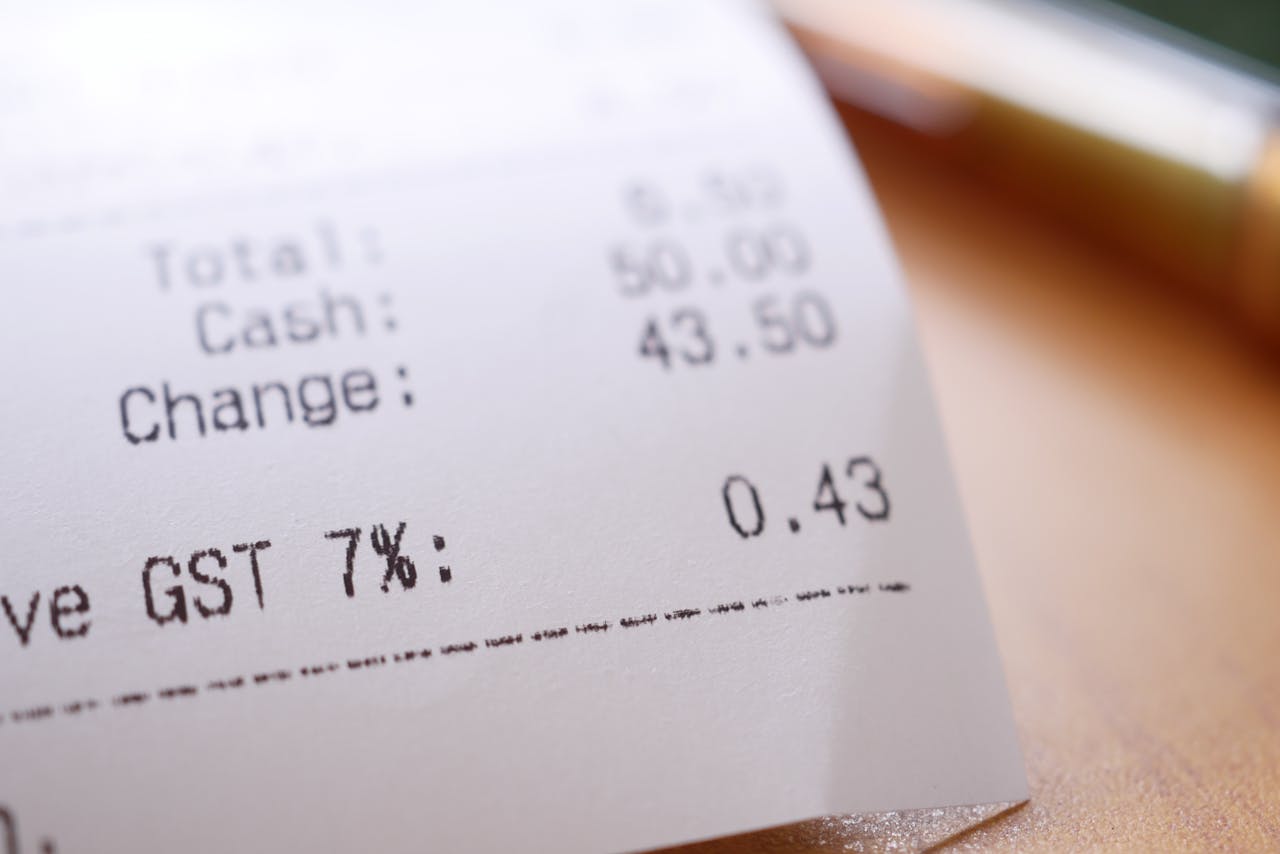 Detailed close-up image of a shopping receipt showing GST and total changes.